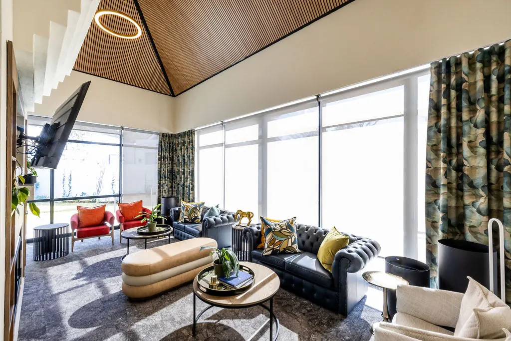Lounge with a vaulted acoustic slat ceiling