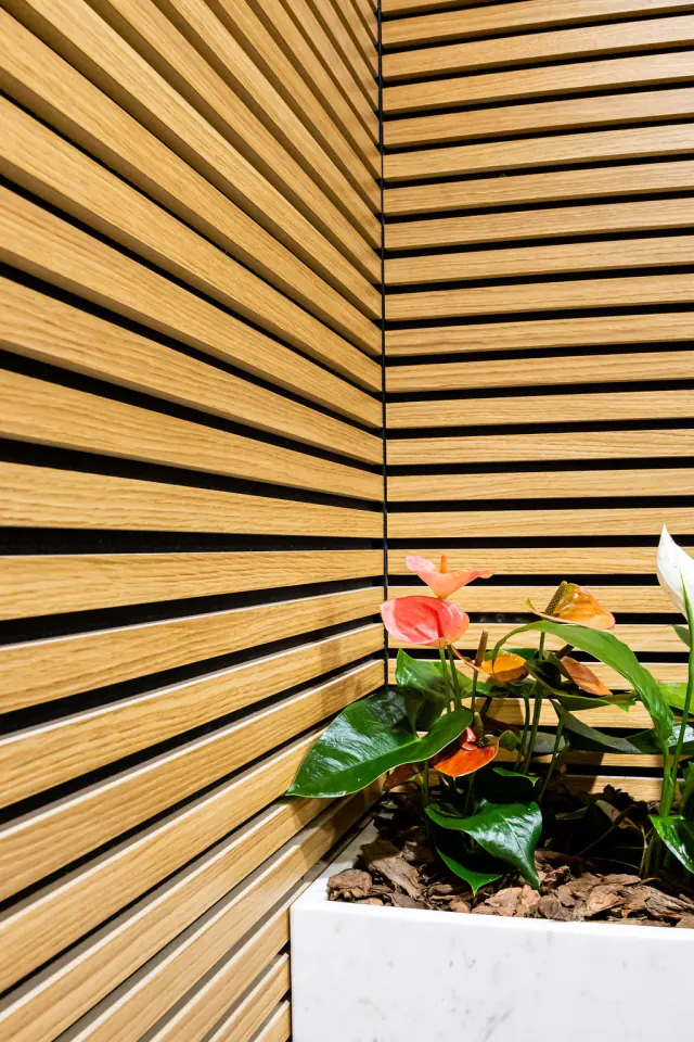 Natural wood-look slatted panel close-up corner detail