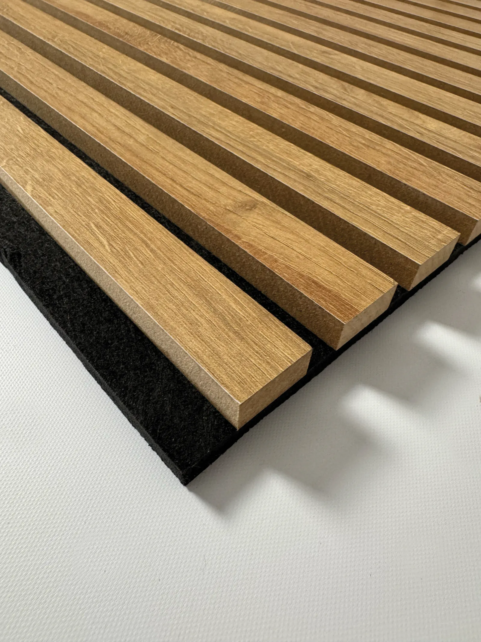 AcoustiSlat panel corner showing the dense polyester fibre acoustic backing